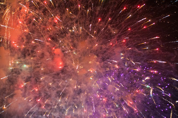 Stunning bright vibrant and colorful fireworks in the night sky during new year celebrations