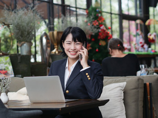 Asian business girl working and drinking coffee in cafe