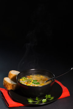 Vegetable soup in a black plate