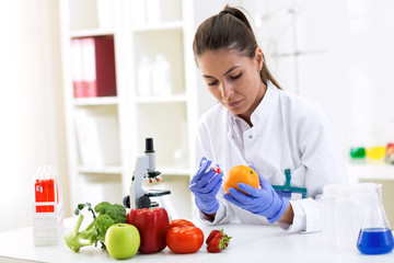 Scientist putting new sample to fruit and cheking results at clinic