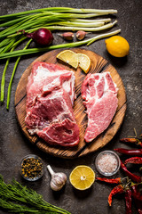 meat fillet of pork with herbs, lemon and spices on a wooden Board