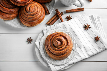 Composition with sweet cinnamon rolls on table