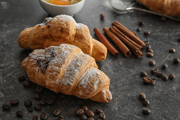 Tasty croissants on dark table