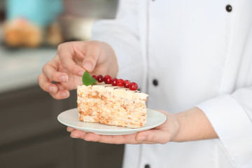 Chef decorating piece of tasty Esterhazy cake, closeup