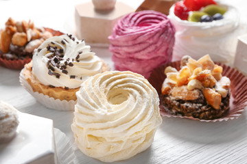 Assortment of tasty sweets on wooden background