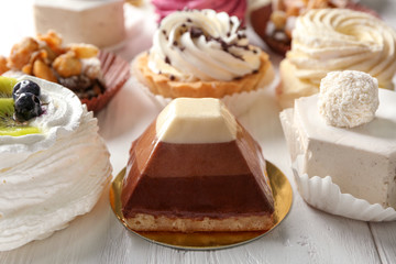 Assortment of tasty sweets on wooden background