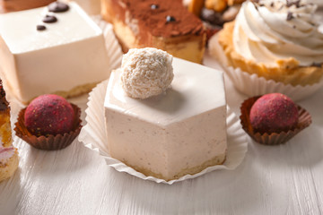 Tasty sweets on wooden background