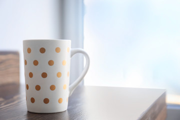 Cup of coffee on window sill
