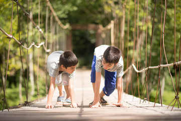Little boy running together over the bridge outdoor activities