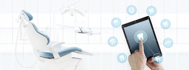 dentist hand touch digital tablet screen teeth icons and symbols on dental clinic with dentist's chair background web banner template contact us concept