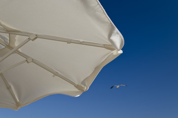 Beach umbrella against the blue clear sky on the beach