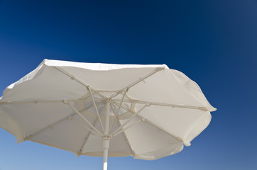 Beach umbrella against the blue clear sky on the beach