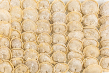 Traditional Russian handmade dumplings frozen on the board. Russian pelmeni. Ravioli