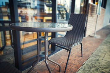 Fototapeta na wymiar outside cafe with glass round table with blur background