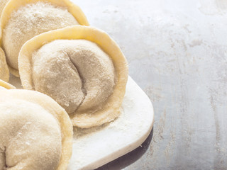 Traditional Russian handmade dumplings frozen on the board. Russian pelmeni. Ravioli