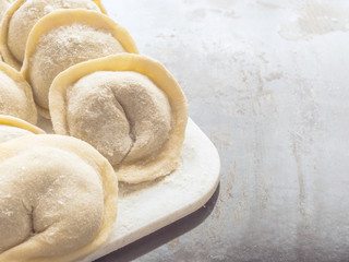 Traditional Russian handmade dumplings frozen on the board. Russian pelmeni. Ravioli