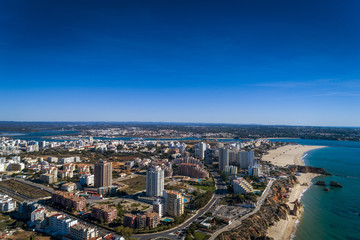 Fototapeta premium Aerial view of the coastline in Rocha Beach (Praia da Rocha) in Portimao, Algarve, Portugal; Concept for travel in Portugal and Algarve