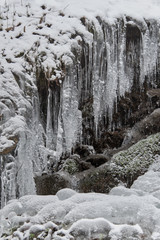 Fototapeta na wymiar ice flowstones and snow in the mountains, nature detail, ice texture