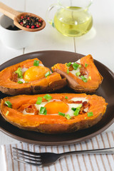 Baked sweet potato with fried egg, bacon and chives.