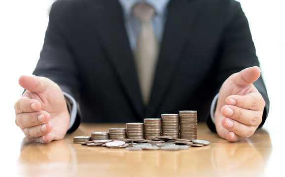Businessman Protect Stack Of Coins
