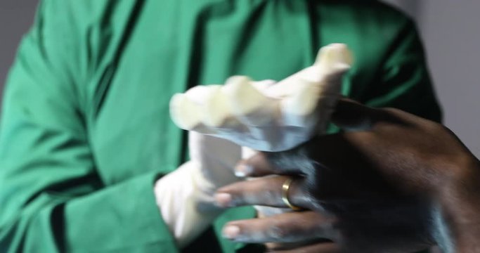 Doctor putting on medical gloves