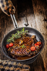 Beef steak. Grill beef flank steak with rosemary musrooms and tomatoes in pan