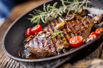 Beef steak. Grill beef flank steak with rosemary musrooms and tomatoes in pan