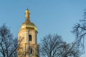 Orthodox belfry in the rays of sunset