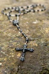 Rosary beads left on a stone