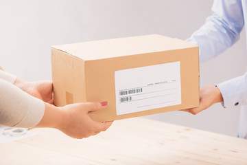 Woman receiving package from a delivery man