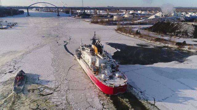 Coastguard Cutter boat breaking ice in the Bay of Green Bay in subzero weather. The effort is made in order to keep shipping lanes open for as long into the Winter as possible.