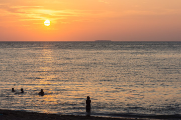 Beach goers at Sunset.
