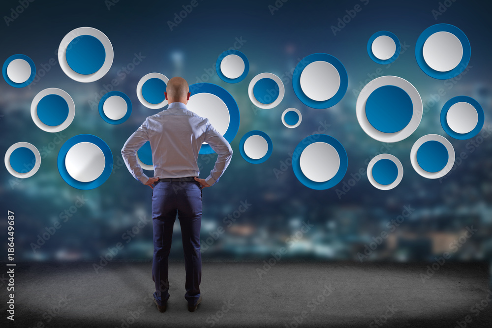 Poster businessman in front of a wall with empty app interface made of blue button displayed on a interface