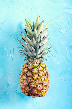 Pineapple fruit over blue background