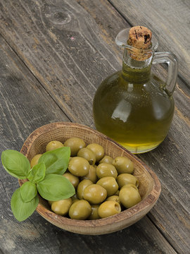 olive oil with olives on a wooden table. 