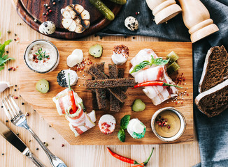 beautiful serving of assorted lard with garlic croutons and mustard on a wooden board