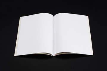 Mock-up magazine, book or catalog on black table. Blank page or notepad on solid background. Blank page or notepad for mockups or simulations.