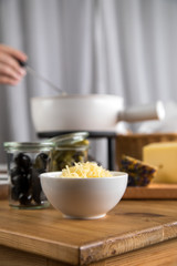 Mann isst klassisches Käse Fondue mit Brot und Käseplatte