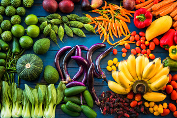 Flat lay of fresh  fruits and vegetables for background, Different fruits and vegetables for eating healthy, Colorful fruits and vegetables on blue plank © peangdao