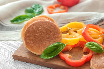 Board with yummy pancakes and pepper on wooden table