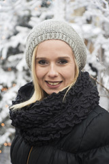 outdoor winter portrait of a young blonde woman out in the snow