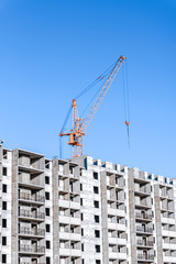 Fototapeta premium Industrial landscape with silhouettes of cranes on the blue sky background