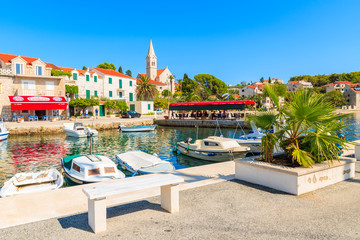 Naklejka premium SUMARTIN PORT, BRAC ISLAND - SEP 13, 2017: Typical fishing boats anchoring in Sumartin port on Brac island, Croatia.