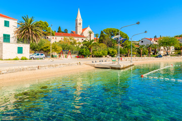 Beach in Sumartin port with beautiful church in background, Brac island, Croatia.