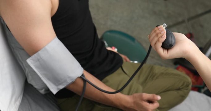 Doctor checking blood pressure on patient