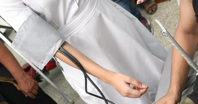 Doctor checking blood pressure on patient