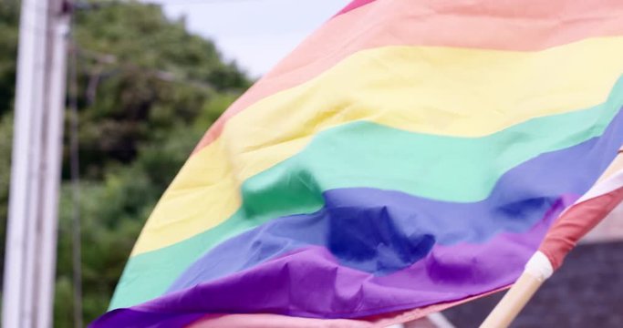 Rainbow flag - gay pride flag flying in wind - slow motion