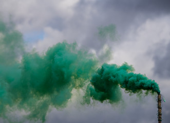 Colorful smoke bombs against a cloudy sky