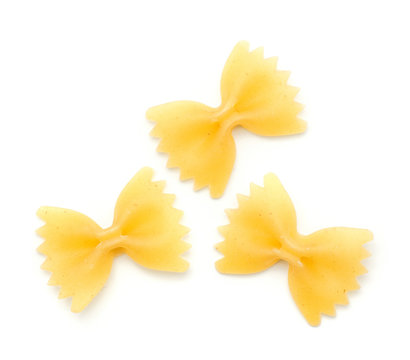 Three raw farfalle pasta isolated on white background top view.