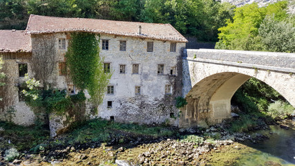 A old house with bridge next to river in middle France